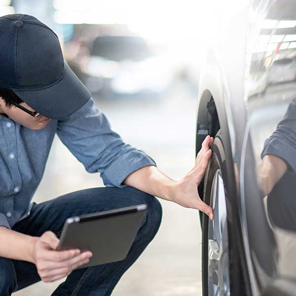 Mechanic checking the car wheel